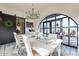 Elegant dining room with arched windows and a view of the patio at 32633 N 137Th St, Scottsdale, AZ 85262