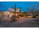 Backyard view of two-story house with pergola and lighting at 32633 N 137Th St, Scottsdale, AZ 85262