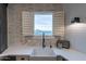 Bright kitchen with a farmhouse sink, brick accent wall, and a window with shutters at 32633 N 137Th St, Scottsdale, AZ 85262