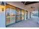 Outdoor patio with sliding glass doors, lighting, and brick pavers at 32633 N 137Th St, Scottsdale, AZ 85262