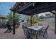 Pergola-covered patio with dining table and fire pit at 32633 N 137Th St, Scottsdale, AZ 85262