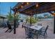 Pergola-covered patio with dining table and string lights at 32633 N 137Th St, Scottsdale, AZ 85262