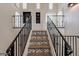 Elegant staircase with patterned tile and metal railings leading to upper level at 32633 N 137Th St, Scottsdale, AZ 85262