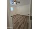 Simple bedroom with wood-look floors and ceiling fan at 3408 W Mclellan Blvd, Phoenix, AZ 85017