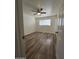 Spacious bedroom with wood-look floors and ceiling fan at 3408 W Mclellan Blvd, Phoenix, AZ 85017