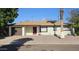 Ranch style home with a brown garage door and red front door at 3408 W Mclellan Blvd, Phoenix, AZ 85017