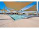 Community pool with shade structures and surrounding deck at 3419 W Dreamy Draw Dr, San Tan Valley, AZ 85144