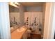 Main bathroom with single sink, shower, and patterned curtain at 3432 E Bartlett Dr, Gilbert, AZ 85234