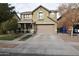 Two story house with tan exterior, attached garage, and landscaping at 3432 E Bartlett Dr, Gilbert, AZ 85234