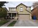 Two story house with tan exterior, attached garage, and landscaping at 3432 E Bartlett Dr, Gilbert, AZ 85234