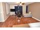 Living room with dark wood floors, sectional sofa and TV at 3432 E Bartlett Dr, Gilbert, AZ 85234