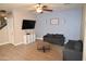 Living room with two sofas, a coffee table, and a blue accent wall at 3432 E Bartlett Dr, Gilbert, AZ 85234