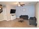 Living room with two sofas, a coffee table, and a blue accent wall at 3432 E Bartlett Dr, Gilbert, AZ 85234