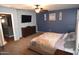 Main bedroom with a large bed, dresser, and blue accent wall at 3432 E Bartlett Dr, Gilbert, AZ 85234