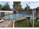 Freeform swimming pool with safety fence and playset at 3432 E Bartlett Dr, Gilbert, AZ 85234