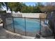 Freeform swimming pool with safety fence at 3432 E Bartlett Dr, Gilbert, AZ 85234