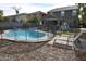 Freeform swimming pool with safety fence and lounge chairs at 3432 E Bartlett Dr, Gilbert, AZ 85234