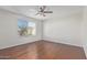 Light and airy bedroom with wood flooring and window at 3947 N Carnation Ln, Avondale, AZ 85392