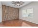 Bright bedroom with wood-look floors and accent wall at 3947 N Carnation Ln, Avondale, AZ 85392