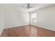 Well-lit bedroom featuring wood floors and a ceiling fan at 3947 N Carnation Ln, Avondale, AZ 85392