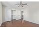 Bright bedroom with wood floors, ceiling fan, and spacious closet at 3947 N Carnation Ln, Avondale, AZ 85392