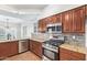 Modern kitchen with stainless steel appliances and granite countertops at 3947 N Carnation Ln, Avondale, AZ 85392