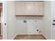 Laundry room with upper cabinets and tiled floor at 3947 N Carnation Ln, Avondale, AZ 85392