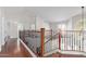 Upstairs hall with wood floors and elegant wood and metal railing at 3947 N Carnation Ln, Avondale, AZ 85392