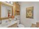 Small bathroom with wood vanity, sunflower painting, and gold mirror at 4102 E Ray Rd # 1006, Phoenix, AZ 85044