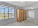 Bedroom with large window, wood wardrobe and mirrored closet at 4102 E Ray Rd # 1006, Phoenix, AZ 85044