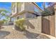 Back exterior view, showing a wooden gate and AC unit at 4102 E Ray Rd # 1006, Phoenix, AZ 85044