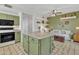 Bright kitchen with green cabinets, granite island, and stainless steel appliances at 4102 E Ray Rd # 1006, Phoenix, AZ 85044