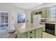 Bright kitchen with island, view of patio, green cabinets at 4102 E Ray Rd # 1006, Phoenix, AZ 85044