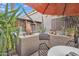 Relaxing patio with built-in BBQ, seating area, and shade umbrella at 4102 E Ray Rd # 1006, Phoenix, AZ 85044