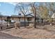 House with a large covered porch, dark railings, and gravel driveway at 4205 E Peak View Rd, Cave Creek, AZ 85331