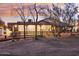 Ranch style home with a large covered porch and mature trees at 4205 E Peak View Rd, Cave Creek, AZ 85331