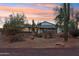 Ranch house with covered porch and desert landscaping at sunset at 4205 E Peak View Rd, Cave Creek, AZ 85331