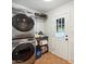 Stackable washer and dryer in a well-lit laundry room with extra storage at 4205 E Peak View Rd, Cave Creek, AZ 85331