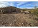 Home's backyard with rocky terrain and desert landscape at 46312 N 38Th Ave, New River, AZ 85087