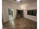 Bedroom with wood-look floors, sliding door to patio, and ceiling fan at 46312 N 38Th Ave, New River, AZ 85087