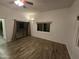 Spacious bedroom with wood-look floors, large windows and sliding glass doors at 46312 N 38Th Ave, New River, AZ 85087