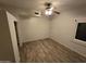 Bright bedroom with wood-look flooring and ceiling fan at 46312 N 38Th Ave, New River, AZ 85087