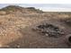 Landscaped lot with a stone firepit and distant home at 46312 N 38Th Ave, New River, AZ 85087