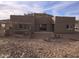 Rear view of a stucco home with a patio and chicken coop at 46312 N 38Th Ave, New River, AZ 85087