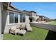 Relaxing patio with seating area, artificial turf, and view of neighboring homes at 4802 S Duffy --, Mesa, AZ 85212