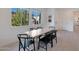 Dining area with a light wood table and black chairs, plenty of natural light at 4802 S Duffy --, Mesa, AZ 85212