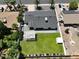 A well-maintained backyard is fully fenced with a white pergola and lush lawn, perfect for outdoor gatherings at 4916 E Kathleen Rd, Scottsdale, AZ 85254