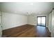 Bright bedroom with wood floors, white accent wall, and sliding glass doors at 4916 E Kathleen Rd, Scottsdale, AZ 85254