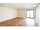 Bedroom with hardwood floors, sliding door, and white wall detail at 4916 E Kathleen Rd, Scottsdale, AZ 85254