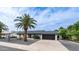 Charming single-story home featuring desert landscaping and a black garage door with a clear blue sky overhead at 4916 E Kathleen Rd, Scottsdale, AZ 85254